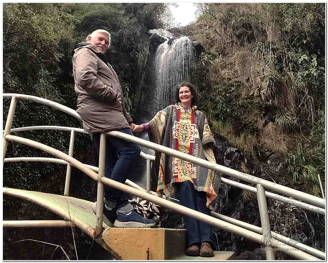 Pareja de viajeros viviendo una experiencia de bienestar en el salto de agua El Chorro, un rincón natural del municipio nariñense