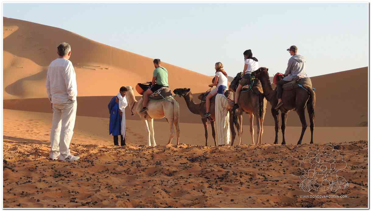 viajeros en camello en el desierto de Erg Chebbi en Marruecos